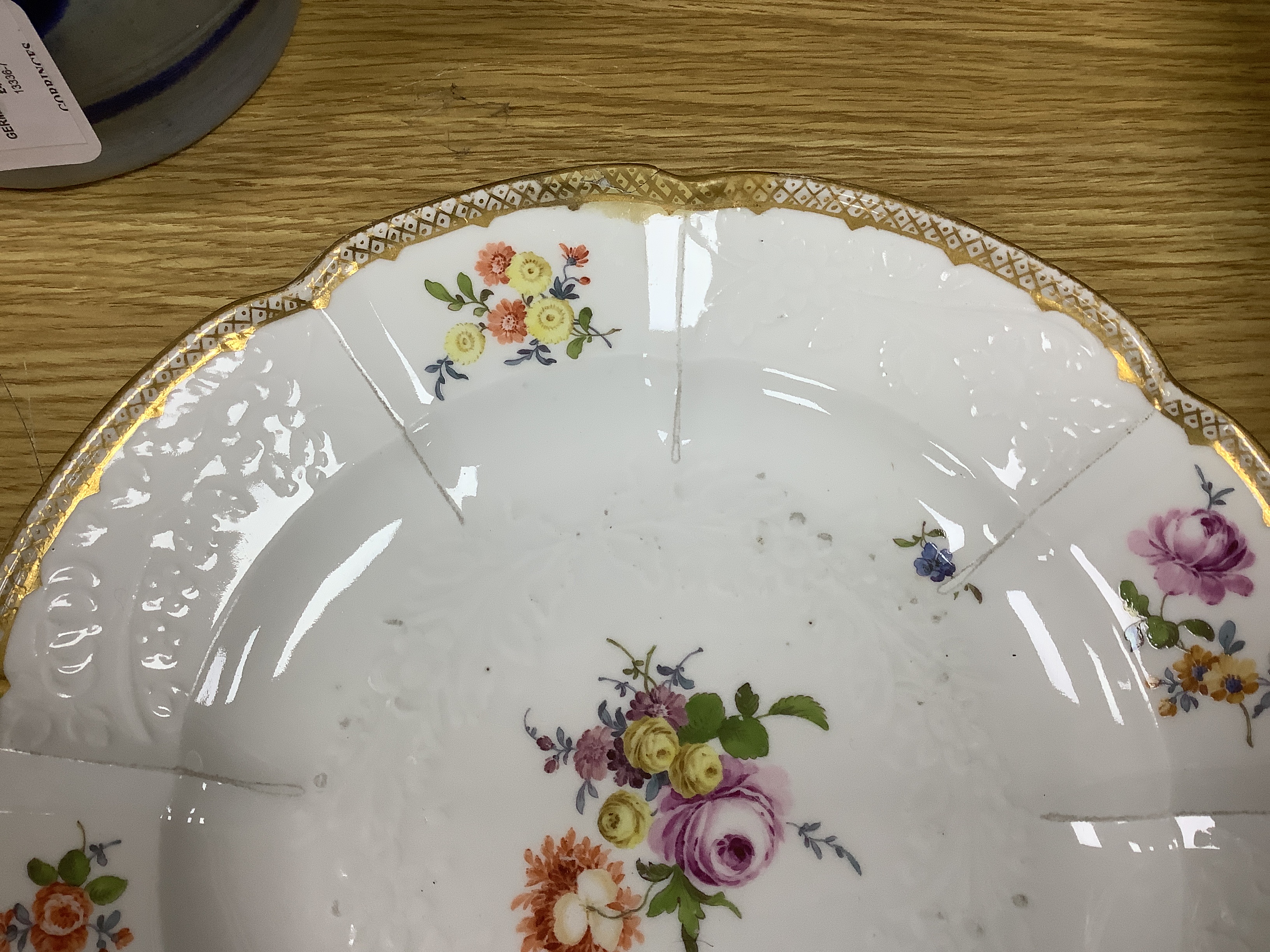 A large Meissen moulded porcelain dish and five matching plates, c.1760-70, each painted with Deutsche Blumen, dish 32cm diameter